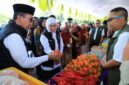 Gubernur Jawa Timur Khofifah Indar Parawansa didampingi Bupati KH. Kholilurrahman memantau aktifitas jual beli dalam kegiatan pasar murah di Pamekasan. (Foto Istimewa)